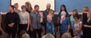 Choir Belrose gig w Cafe - Fi and Graham waving hands 1